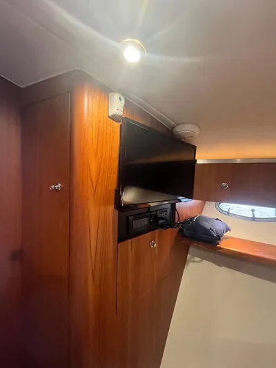 Papa Joe Yacht Photos Pics Interior of a 2006 Tiara Yachts 3600 Open, featuring wood paneling and a mounted TV.
