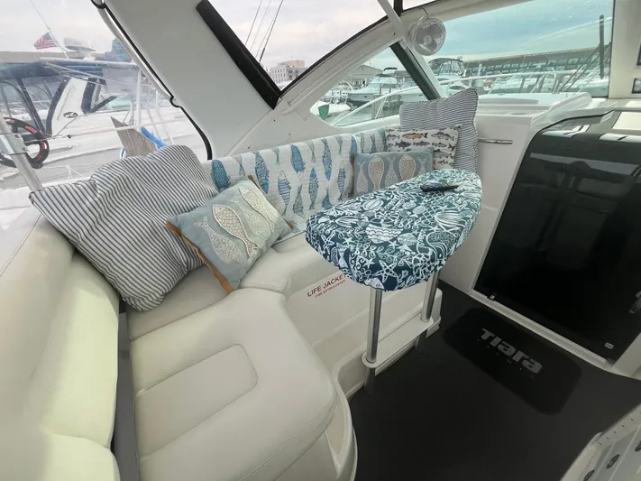 Papa Joe Yacht Photos Pics Interior of 2006 Tiara Yachts 3600 Open with cozy seating and nautical-themed cushions.