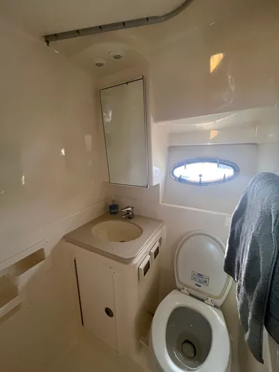 Papa Joe Yacht Photos Pics Bathroom interior of 2006 Tiara Yachts 3600 Open, featuring sink, toilet, and porthole window.