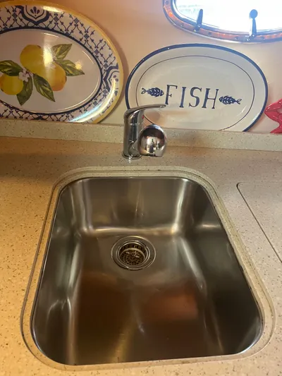 Papa Joe Yacht Photos Pics Stainless steel sink in 2006 Tiara Yachts 3600 Open, with decorative plates in background.