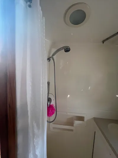 Papa Joe Yacht Photos Pics Shower area in 2006 Tiara Yachts 3600 Open, featuring a handheld showerhead and curtain.
