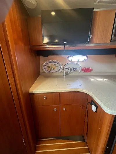 Papa Joe Yacht Photos Pics 2006 Tiara Yachts 3600 Open interior with TV, wooden cabinets, and countertop.