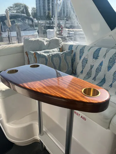 Papa Joe Yacht Photos Pics Luxurious interior of 2006 Tiara Yachts 3600 Open with elegant wooden table and nautical cushions.