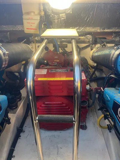 Papa Joe Yacht Photos Pics Engine room of 2006 Tiara Yachts 3600 Open, featuring red machinery and metal railings.