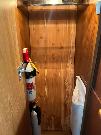 Papa Joe Yacht Photos Pics Wooden storage compartment on a 2006 Tiara Yachts 3600 Open, featuring fire extinguishers.