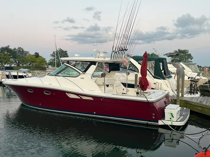 Papa Joe Yacht Photos Pics 2006 Tiara Yachts 3600 Open docked, featuring a sleek red hull and fishing rods.