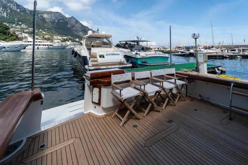  Yacht Photos Pics Vicem 54 Classic Flybridge 2006 yacht docked in scenic marina with mountain backdrop.