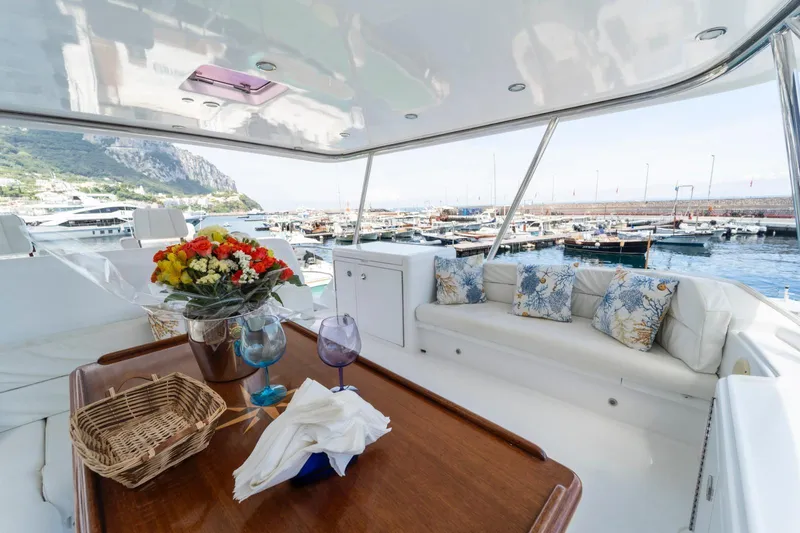  Yacht Photos Pics Luxurious 2006 Vicem 54 Classic Flybridge yacht with elegant seating and scenic marina view.