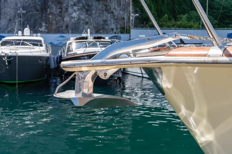  Yacht Photos Pics Bow of 2006 Vicem 54 Classic Flybridge yacht with anchor, docked in marina.