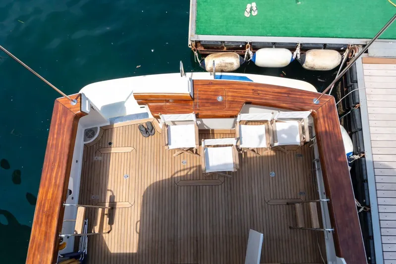  Yacht Photos Pics Vicem 54 Classic Flybridge 2006 yacht deck with wooden finish and seating area.