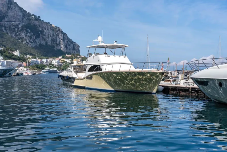 Yacht Photos Pics 2006 Vicem 54 Classic Flybridge yacht docked in scenic marina with mountainous backdrop.