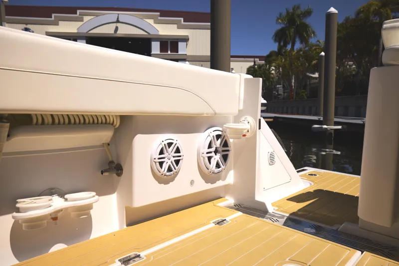 New! Hybrid Design Yacht Photos Pics Century NAV4100 CC-H (Twins) 2025 boat interior with speakers and dock view.