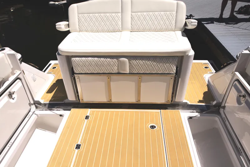 New! Hybrid Design Yacht Photos Pics Century NAV4100 CC-H (Twins) 2025 boat interior with cushioned seating and teak flooring.