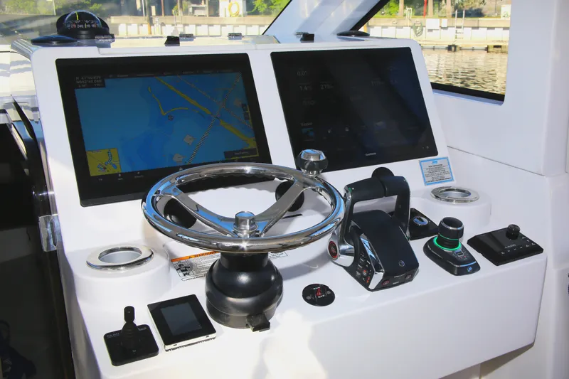 New! Hybrid Design Yacht Photos Pics Control panel of 2025 Century NAV4100 CC-H boat with navigation screens and steering wheel.