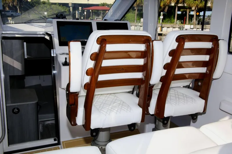 New! Hybrid Design Yacht Photos Pics Interior of 2025 Century NAV4100 CC-H boat with twin captain chairs.