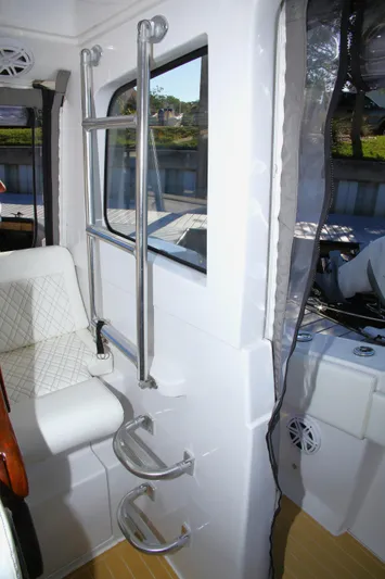 New! Hybrid Design Yacht Photos Pics Interior of 2025 Century NAV4100 CC-H boat with seating and ladder.