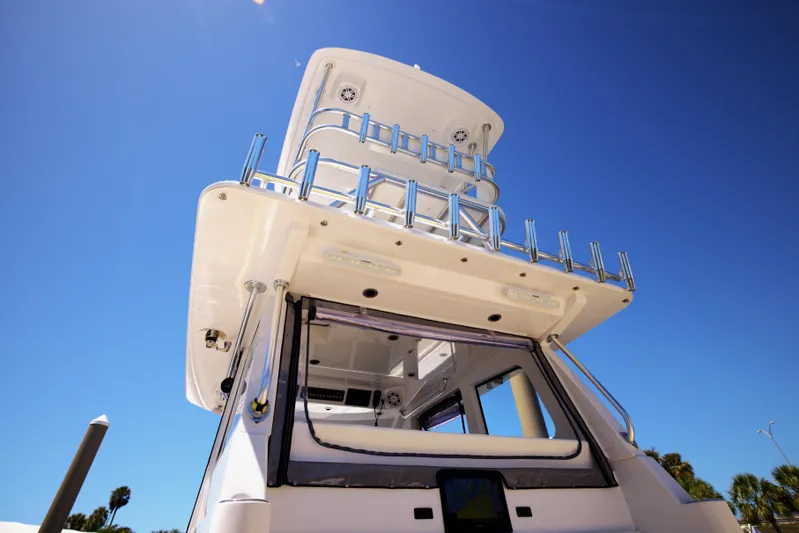 New! Hybrid Design Yacht Photos Pics 2025 Century NAV4100 CC-H boat, viewed from below, showcasing sleek design against clear blue sky.