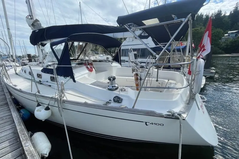 "snapdragon" Yacht Photos Pics Sailboat docked at marina, 1999 Tartan 4100, featuring sleek design and Canadian flag.