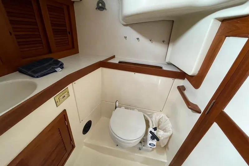 "snapdragon" Yacht Photos Pics 1999 Tartan 4100 yacht bathroom with wooden accents and compact design.