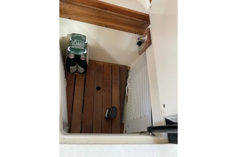 "snapdragon" Yacht Photos Pics 1999 Tartan 4100 interior storage with wooden flooring and beverage pack.