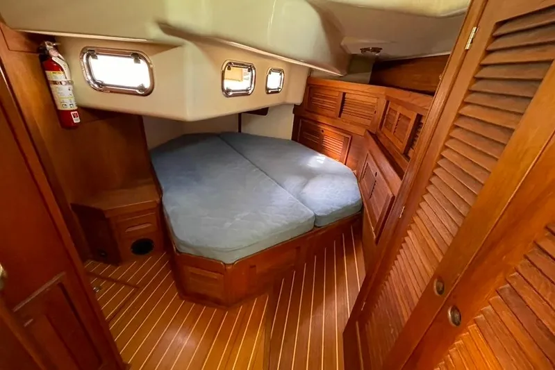 "snapdragon" Yacht Photos Pics Cozy cabin interior of 1999 Tartan 4100 sailboat with wooden finish and double berth.