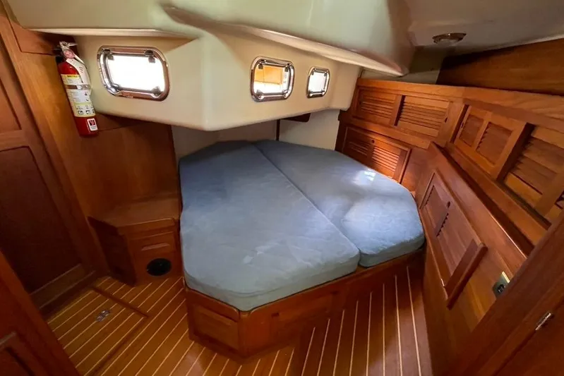 "snapdragon" Yacht Photos Pics Cozy cabin interior of 1999 Tartan 4100 sailboat with wooden finish and portholes.