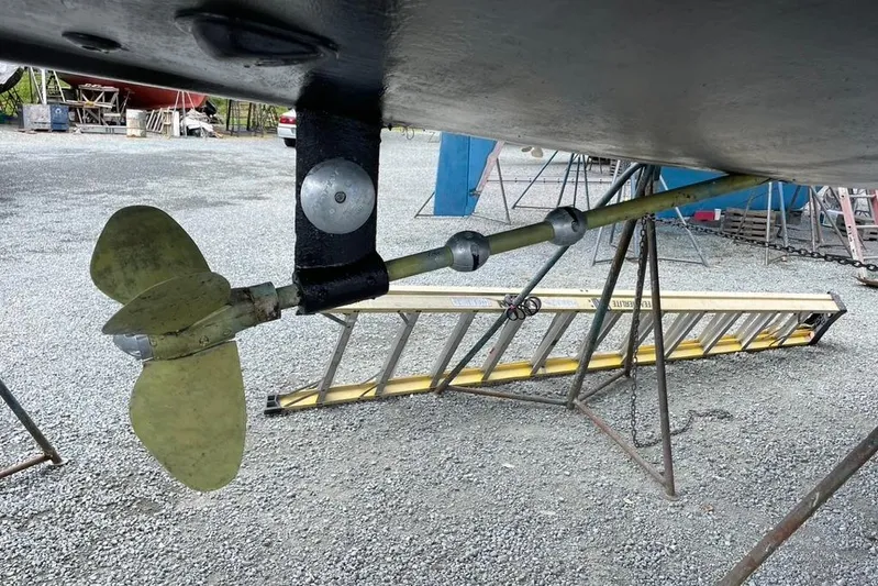 "snapdragon" Yacht Photos Pics Underwater view of a 1999 Tartan 4100 sailboat propeller and shaft on a gravel surface.