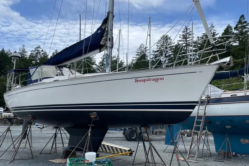 "snapdragon" Yacht Photos Pics Sailboat "Snapdragon" Tartan 4100, 1999 model, on stands in a boatyard with trees in background.