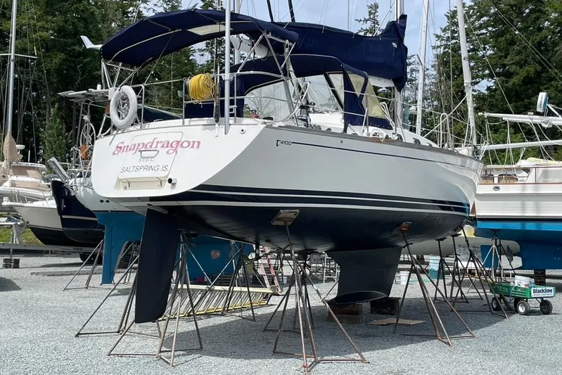 "snapdragon" Yacht Photos Pics 1999 Tartan 4100 sailboat "Snapdragon" on stands, outdoor storage, forest background.