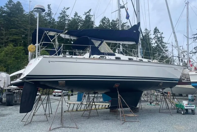 "snapdragon" Yacht Photos Pics 1999 Tartan 4100 sailboat on stands, surrounded by trees and other boats.
