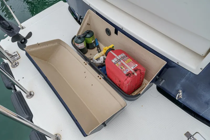 C-worthy III Yacht Photos Pics Open storage compartment on 2014 Cutwater C-30 SC LE boat with fuel can and supplies.