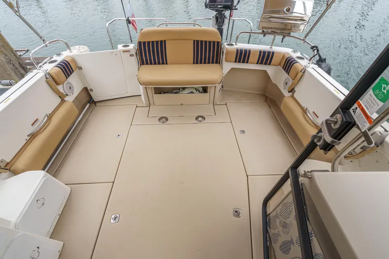 C-worthy III Yacht Photos Pics 2014 Cutwater C-30 SC LE boat deck with beige seating and striped cushions.