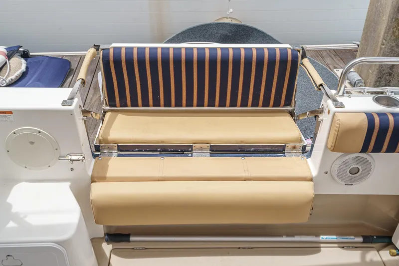 C-worthy III Yacht Photos Pics 2014 Cutwater C-30 SC LE boat seating with striped cushions and beige upholstery.