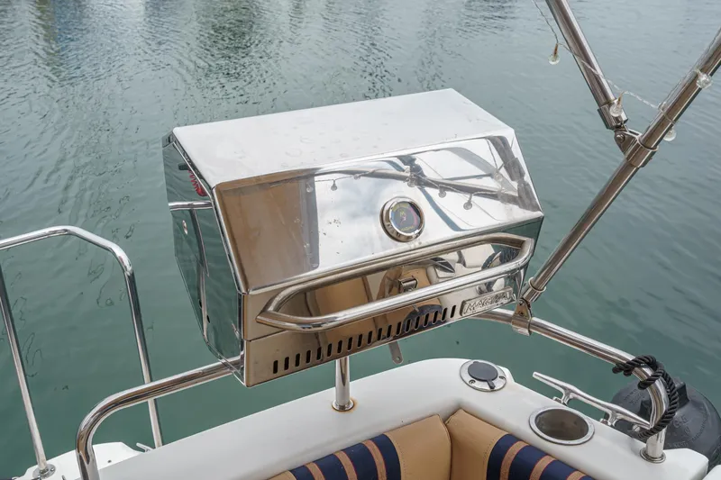 C-worthy III Yacht Photos Pics Stainless steel grill on 2014 Cutwater C-30 SC LE boat, docked on calm water.