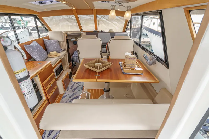 C-worthy III Yacht Photos Pics 2014 Cutwater C-30 SC LE interior with dining area, wooden table, and cozy seating.