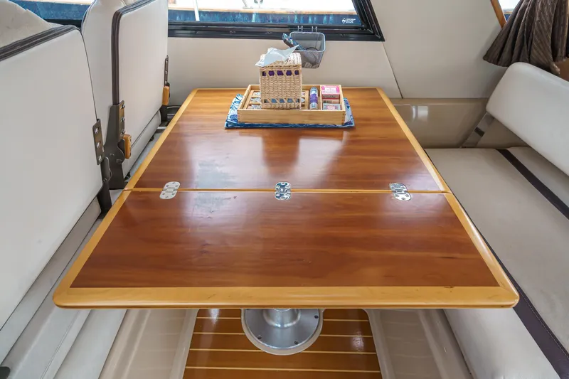 C-worthy III Yacht Photos Pics Interior of 2014 Cutwater C-30 SC LE with wooden table and seating area.