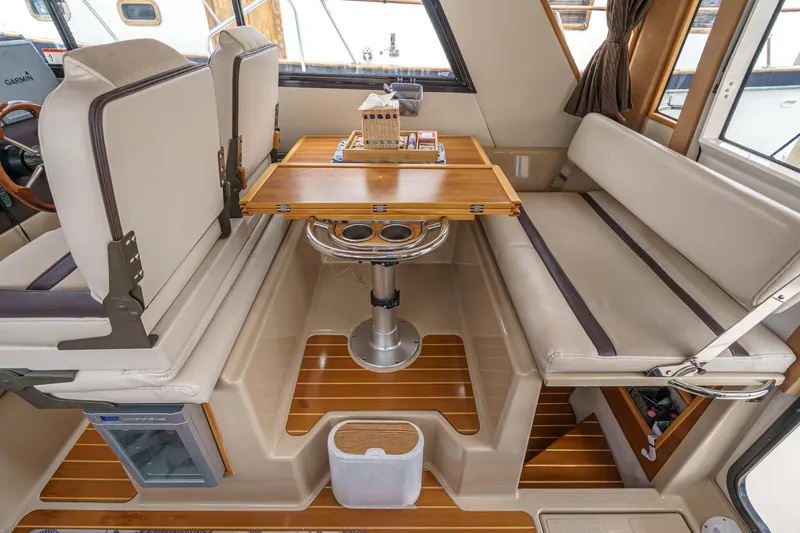 C-worthy III Yacht Photos Pics Interior of 2014 Cutwater C-30 SC LE boat with seating and wooden table.