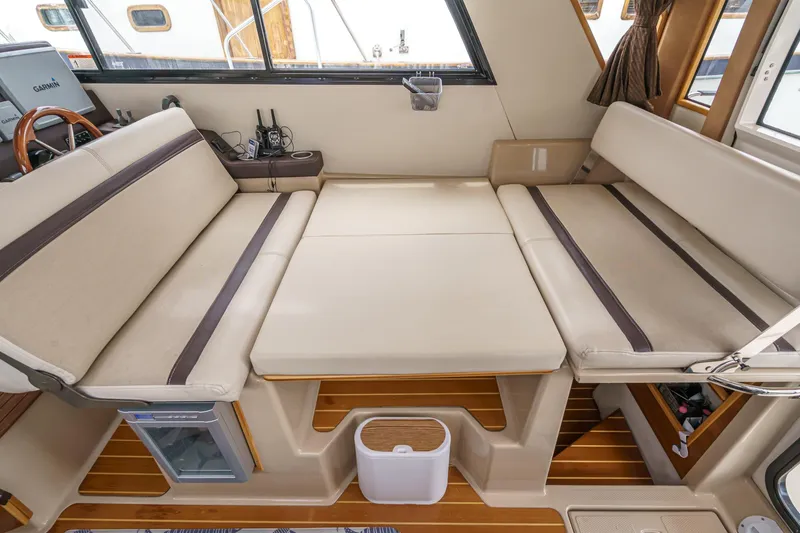 C-worthy III Yacht Photos Pics Interior of 2014 Cutwater C-30 SC LE boat with convertible seating and wooden flooring.