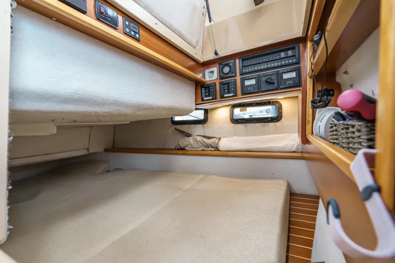 C-worthy III Yacht Photos Pics 2014 Cutwater C-30 SC LE cabin interior with control panels and cozy sleeping area.