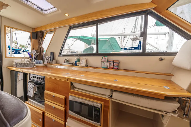 C-worthy III Yacht Photos Pics Interior of 2014 Cutwater C-30 SC LE boat with kitchen amenities and wooden cabinetry.