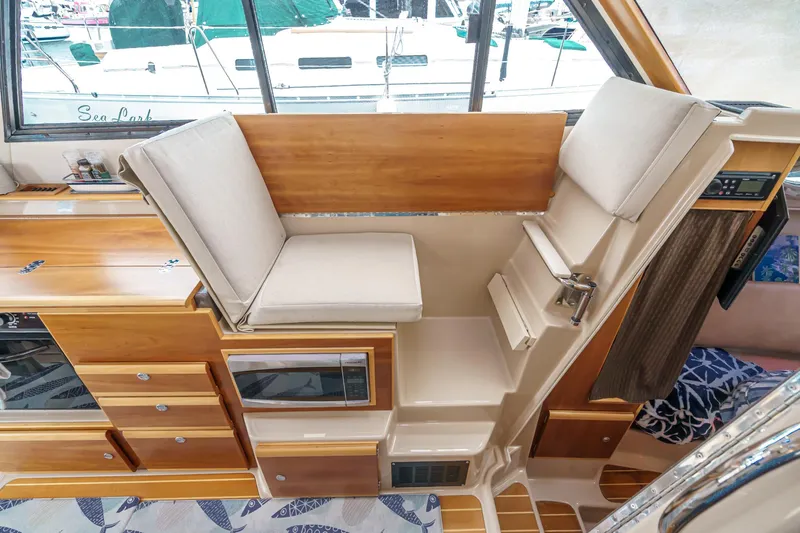 C-worthy III Yacht Photos Pics 2014 Cutwater C-30 SC LE interior with wooden cabinetry and cushioned seating.