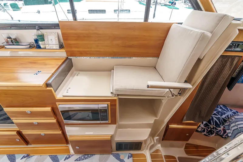 C-worthy III Yacht Photos Pics Interior of 2014 Cutwater C-30 SC LE boat with wooden cabinetry and cushioned seating.