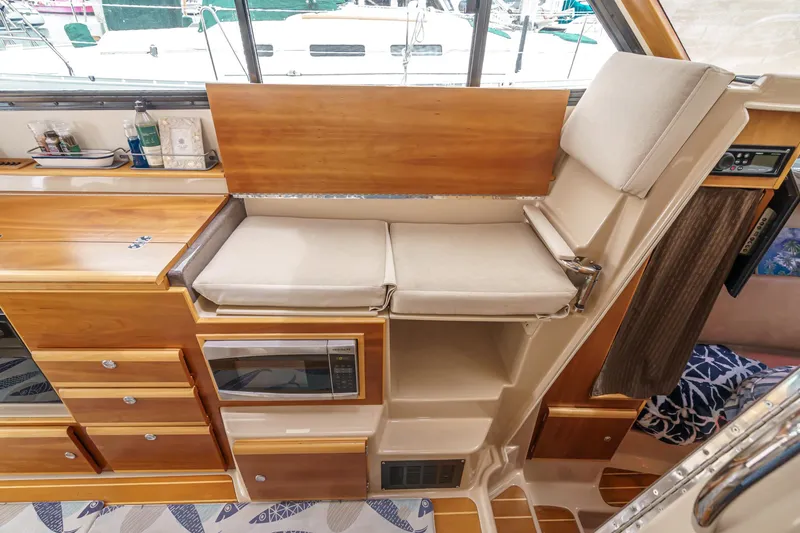 C-worthy III Yacht Photos Pics Interior of 2014 Cutwater C-30 SC LE boat with wooden cabinetry and cushioned seating.