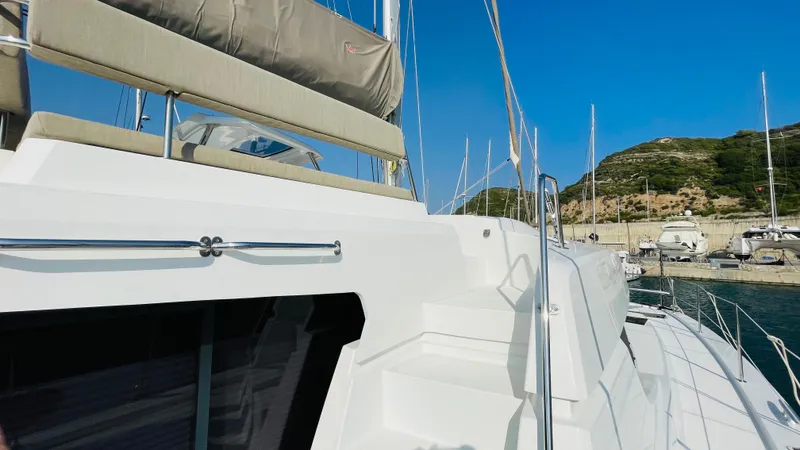  Yacht Photos Pics Modern Bali 4.4 catamaran docked at marina, showcasing sleek design and spacious deck.