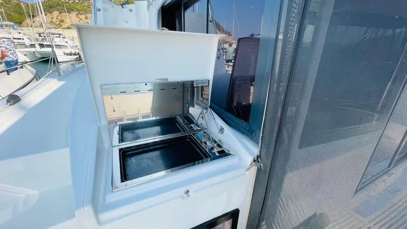  Yacht Photos Pics Outdoor grill on a 2022 Bali 4.4 yacht, docked at a marina.