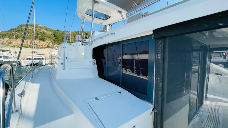  Yacht Photos Pics Modern Bali 4.4 catamaran docked at marina, showcasing sleek design and spacious deck.