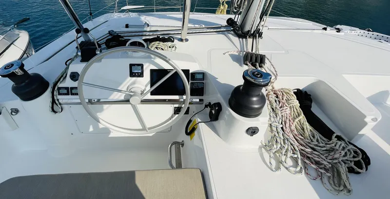  Yacht Photos Pics 2022 Bali 4.4 yacht helm with steering wheel, ropes, and navigation equipment.