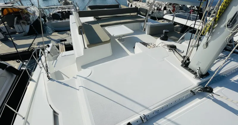  Yacht Photos Pics Modern 2022 Bali 4.4 catamaran deck with seating and table, docked at marina.