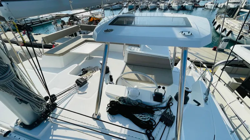  Yacht Photos Pics Modern Bali 4.4 yacht deck, 2022 model, docked at marina with ropes and seating area.