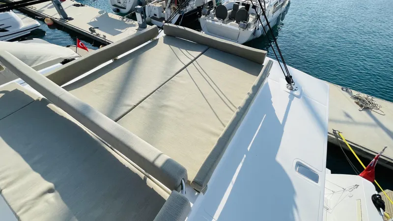  Yacht Photos Pics Sunbathing area on a 2022 Bali 4.4 catamaran, docked at a marina.